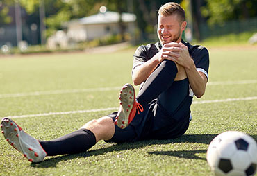 Soccer player suffering with sports injury