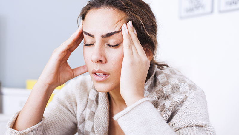 Woman suffering from intense headache